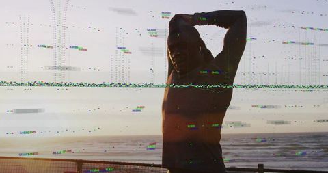 Silhouette man standing and stretching on seaside boardwalk at sunset with digital glitch