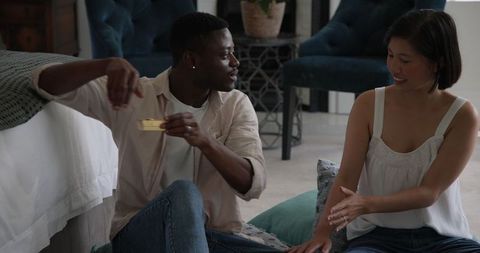 Diverse friends communicating and laughing together indoors