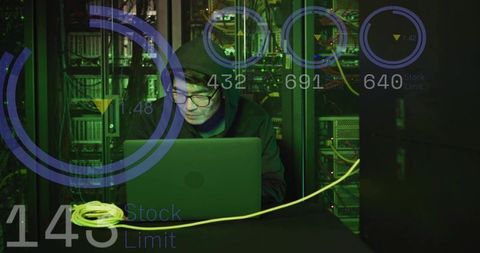 Korean it technician monitoring laptop and network racks with hud overlay in data center