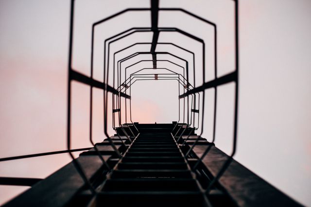 Looking Up Industrial Ladder Cage Against Pink Sky at Dusk - Download Free Stock Images Pikwizard.com