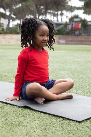 Young Girl in Yoga Pose at Outdoor Playground