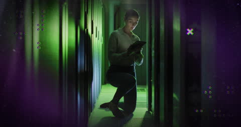 Female Engineer Analyzing Data in Server Room with Digital Tablet