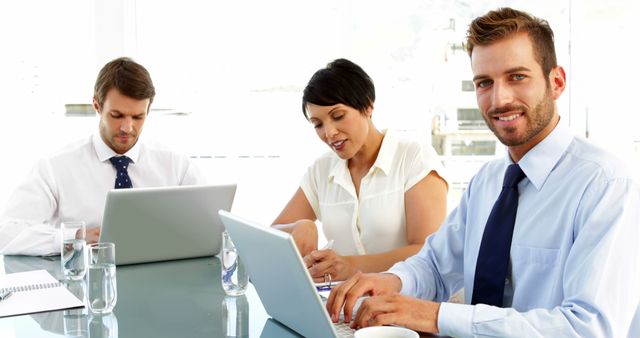 Business Team Working on Laptops in Office Meeting - Download Free Stock Images Pikwizard.com