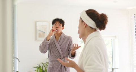 Couple brushing teeth together during relaxed morning routine