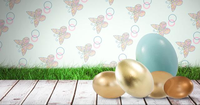 Colorful Easter eggs, including metallic gold ones, are placed on a wooden surface against a background of grass and decorative patterned wall. Ideal for celebrating Easter-themed promotions, seasonal greetings, and festive decor projects.
