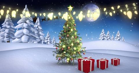 Christmas Tree Glowing with Decorations in Snowy Landscape