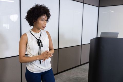 Professional Woman Presenting in Modern Office Setting