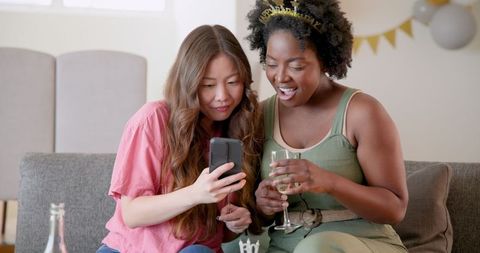 Joyful Friends Drinking Champagne and Celebrating at Home Party