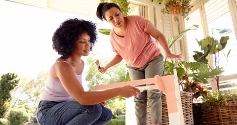 Women enjoying diy furniture painting together