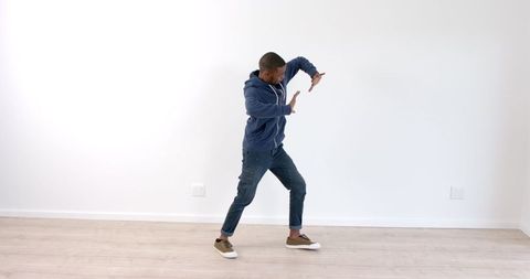 Young man practicing martial arts moves in casual attire