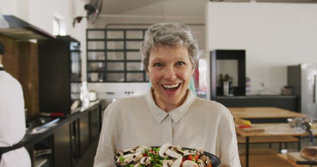 Senior Woman Preparing Fresh Salad in Modern Kitchen - Download Free Stock Images Pikwizard.com