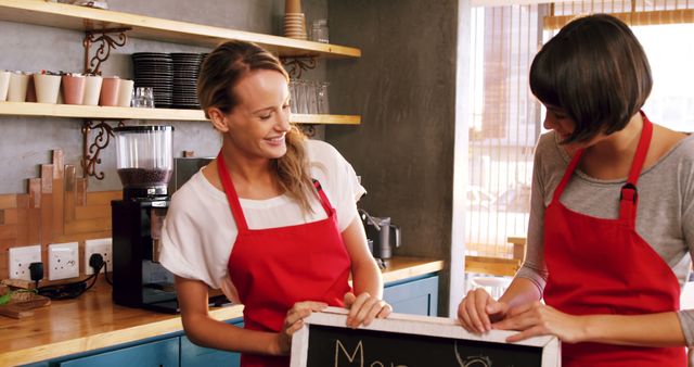 Smiling Baristas with Menu Sign in Coffee Shop - Download Free Stock Images Pikwizard.com