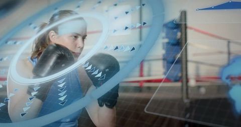 Female boxer training with futuristic hud overlay in boxing ring