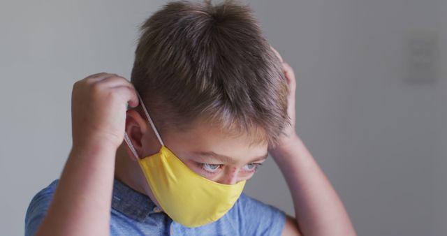 Young Boy Wearing a Yellow Face Mask for Health Safety - Download Free Stock Images Pikwizard.com
