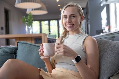 Young woman relaxing at home with coffee