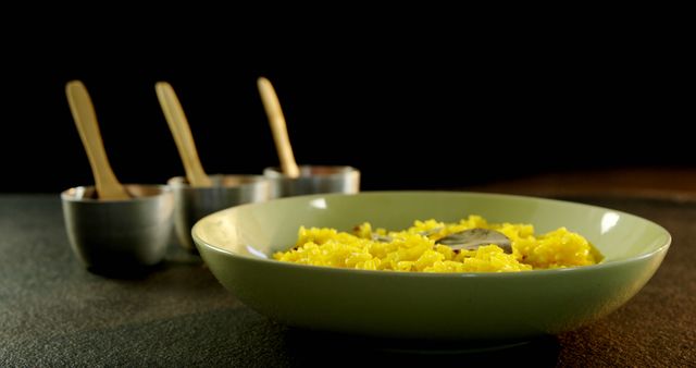 Yellow Saffron Rice in Bowl with Wooden Cutlery and Metallic Cups - Download Free Stock Images Pikwizard.com