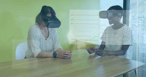 Women collaborating with vr headsets and hud overlays in modern office for data analytics