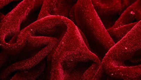 Deep red plush blanket displaying dense pile and luxurious soft folds