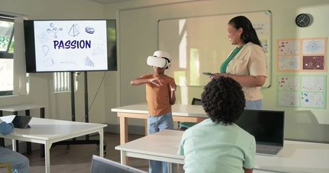 African American Teacher Guiding Students with VR Headset in Passion-Driven STEM Classroom