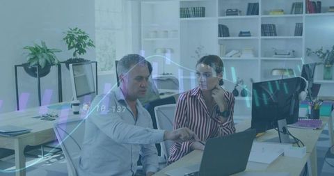 Manager Pointing at Laptop Explaining Data Charts to Colleague in Modern Open Office