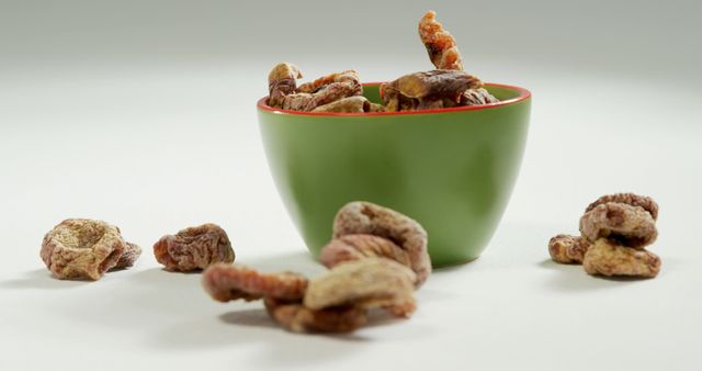 Green Bowl of Dried Figs on White Surface with Copy Space - Download Free Stock Images Pikwizard.com