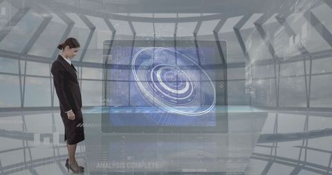 Businesswoman analyzing holographic display in tech control center