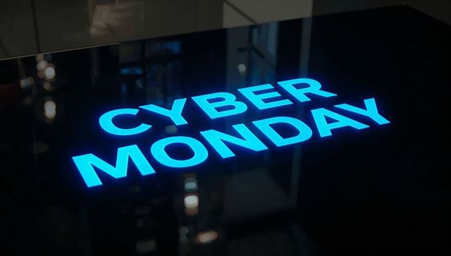 Neon cyan cyber monday glowing sign on glossy black reflective panel for online sales