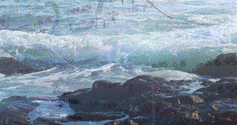 Crashing waves rolling over rocky shore with financial chart overlay, surf seascape