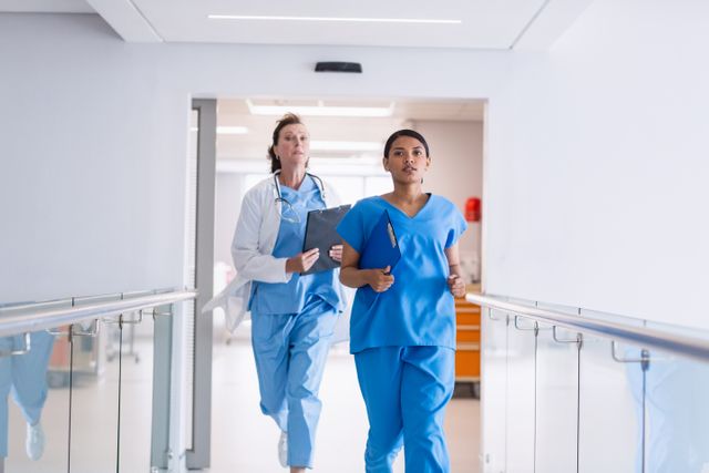 Medical Staff Running in Hospital Hallway during Emergency - Download Free Stock Photos Pikwizard.com