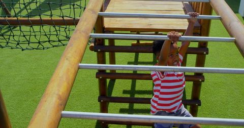 Child Hanging on Playground Horizontal Ladder on Sunny Day - Download Free Stock Images Pikwizard.com
