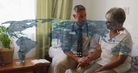 Doctor holding hands with senior patient during telemedicine consult with data overlay
