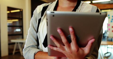 Business person using digital tablet in modern office