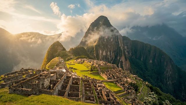 Sunlit machu picchu inca ruins on andes ridge at golden hour with terraced stonework