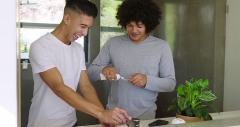 Father and Son Laughing Together During Bathroom Routine