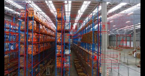 Storing inventory in high-capacity warehouse aisle with blue-orange racking and pallets