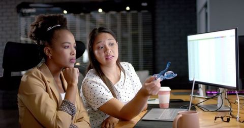 Diverse Businesswomen Collaborating in Office with Computer