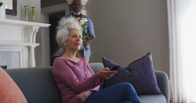 Senior Couple Relaxing at Home, Watching TV and Holding Flowers - Download Free Stock Images Pikwizard.com