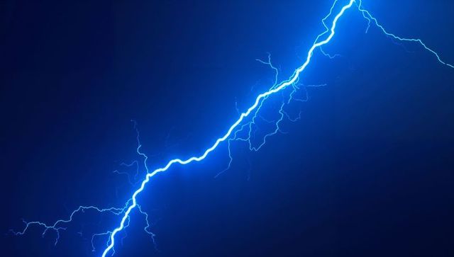 Electric blue lightning bolt flashing across night sky
