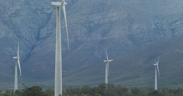 General view of wind turbines in countryside landscape with mountains. environment, sustainability, ecology, renewable energy, global warming and climate change awareness.