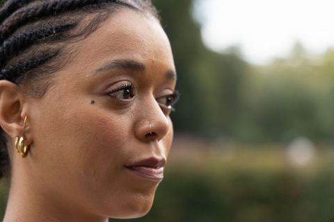 Closeup profile of african american woman with cornrow braids and gold nose hoop