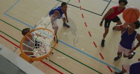 Aerial basketball players vying for rebound under hoop with AR globe overlay
