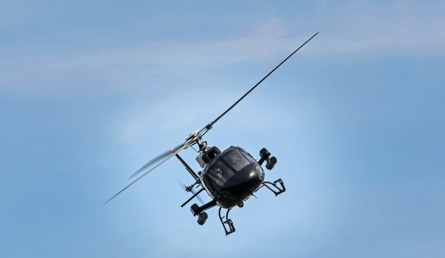 Military Helicopter Flying in Clear Blue Sky - Download Free Stock Photos Pikwizard.com