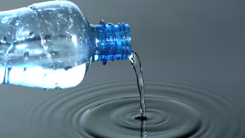 Water Pouring from Plastic Bottle Creating Waves