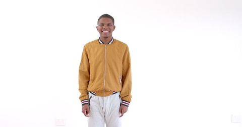 Confident smiling man in casual jacket against white background