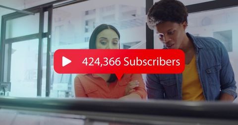 Young professionals collaborating over monitor celebrating 424,366 subscribers and growth