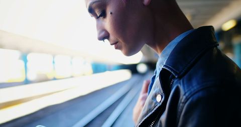 Young Woman Waiting at Train Station Checking Phone - Download Free Stock Images Pikwizard.com
