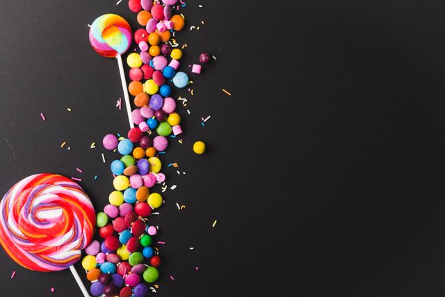 Colorful Lollipops and Candies on Black Background - Download Free Stock Photos Pikwizard.com