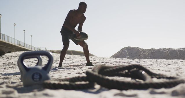 Athletic Man Exercising with Battle Ropes on Sunny Beach - Download Free Stock Images Pikwizard.com