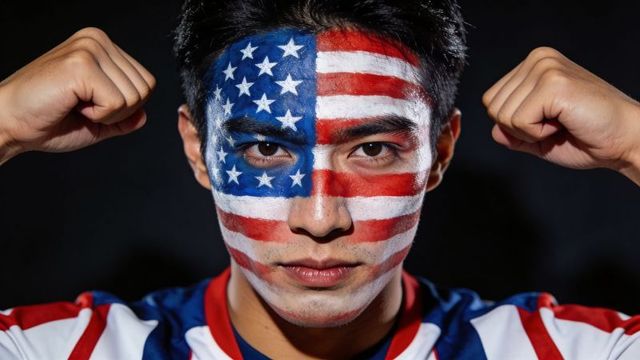 Young man displaying american flag face paint wearing patriotic jersey raising clenched fists
