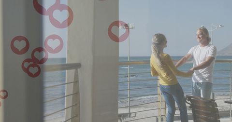 Couple Dancing on Beach Balcony with Heart Icons